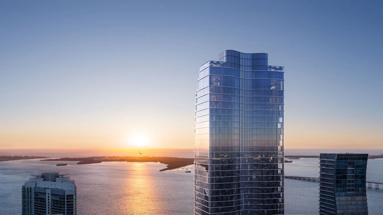Rendering of The Residences at 1428 Brickell tower at sunset, with Biscayne Bay and Key Biscayne in the background.