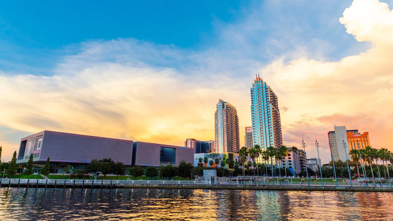 Tampa Museum of Art and downtown towers seen across the Hillsborough River at sunset.
