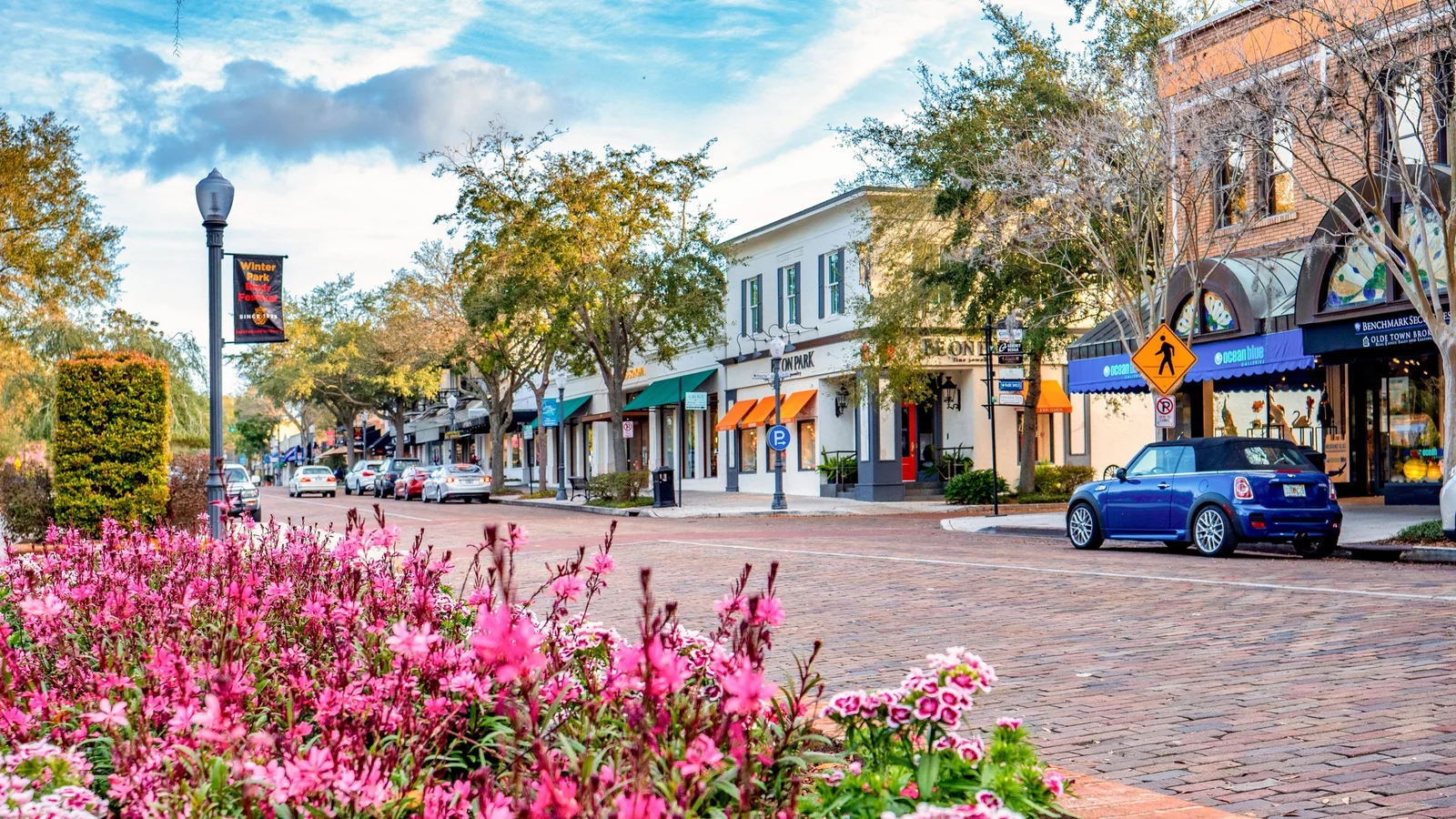 Shops and flower beds along brick-paved Park Avenue in Winter Park, near Orlando.