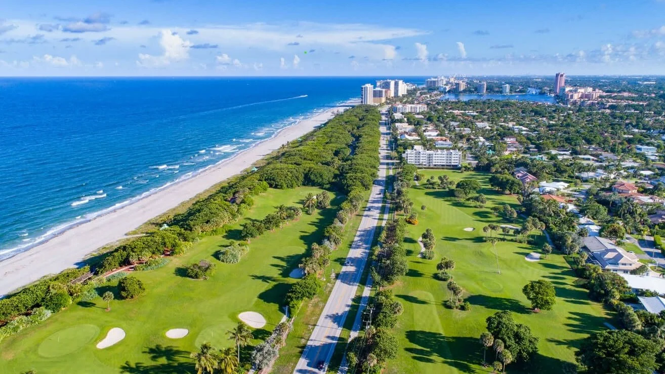 Aerial view of the Boca Raton coast with homes, a golf course and the ocean