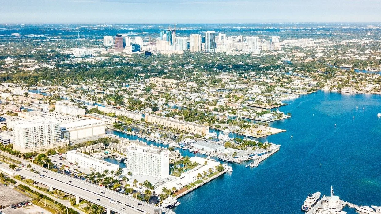 Aerial view of Fort Lauderdale neighborhoods, marinas and waterways with the downtown skyline behind
