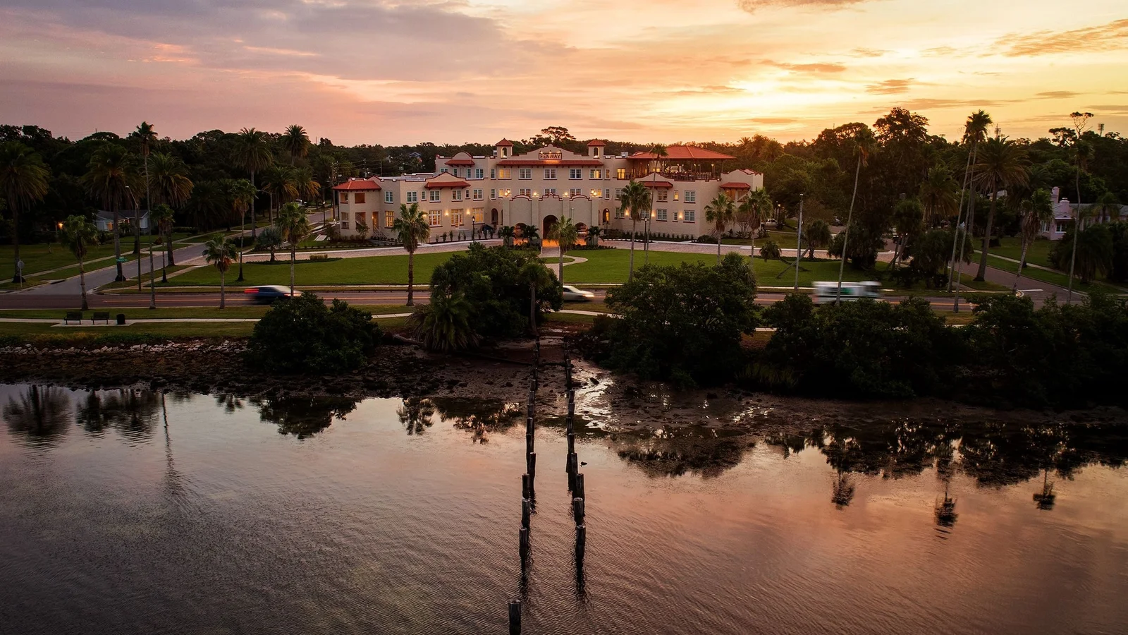 Historic waterfront hotel and lawn at sunrise in Dunedin, Florida.