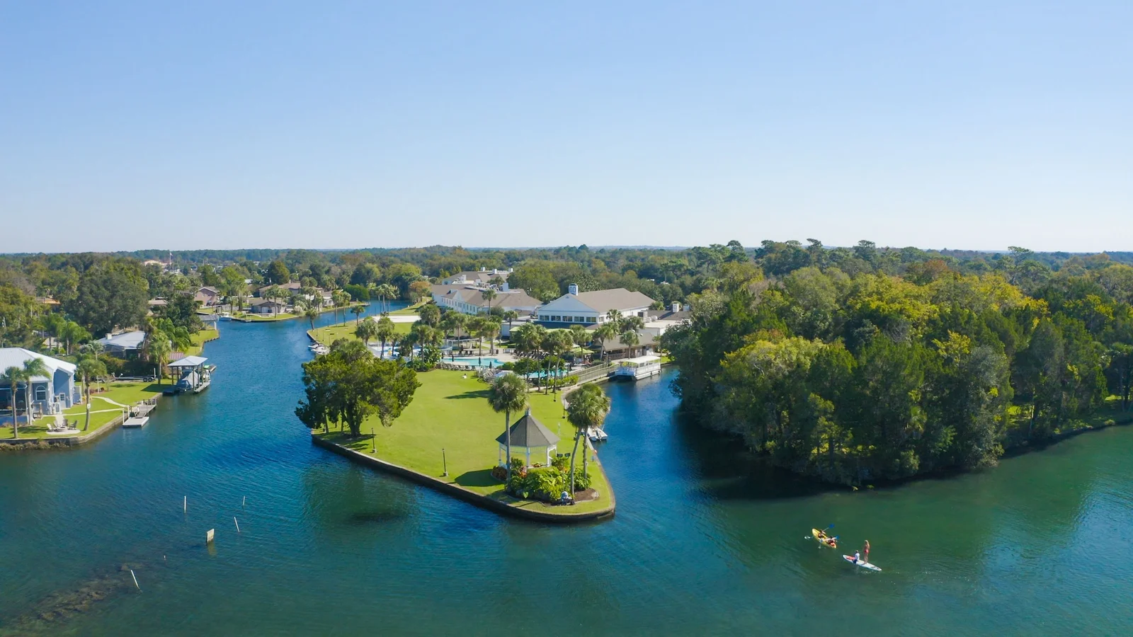 Aerial view of Kings Bay in Crystal River with waterfront homes and a small park island