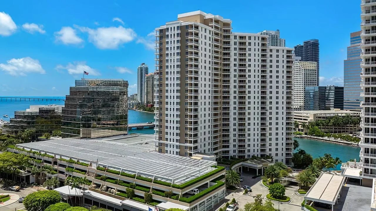 The Courvoisier Courts condo tower on Brickell Key, with the Miami River and downtown towers behind it.