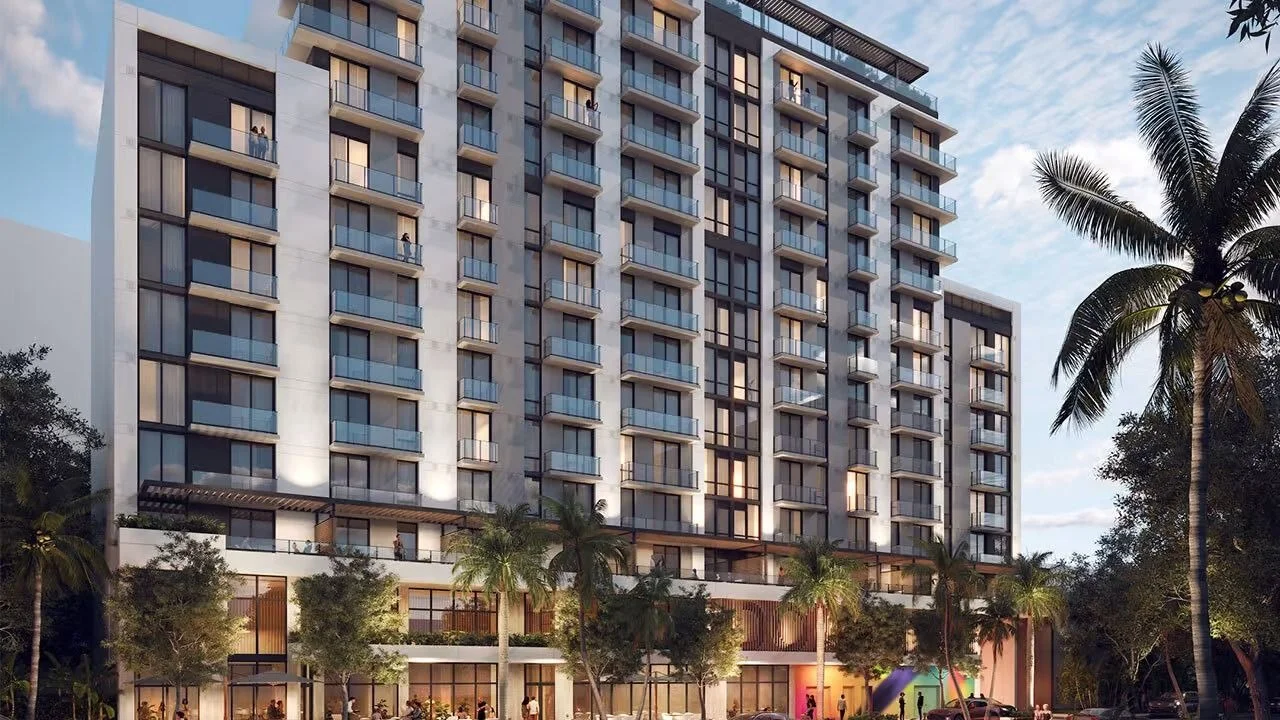 Rendering of the Domus Brickell Park building at dusk, with lit balconies and palm trees in front.