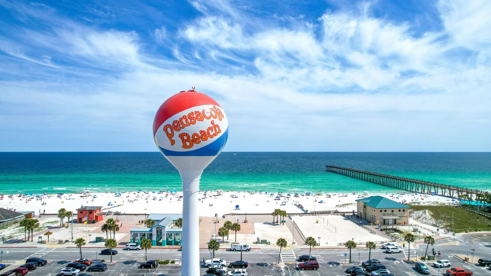 Pensacola Beach water tower above the white sand, Gulf water and fishing pier