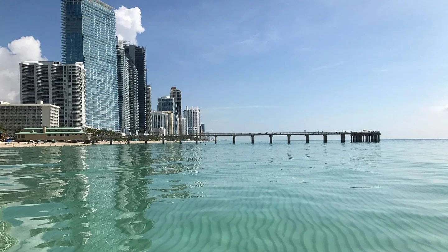 Sunny Isles Beach condo towers and fishing pier seen from the water