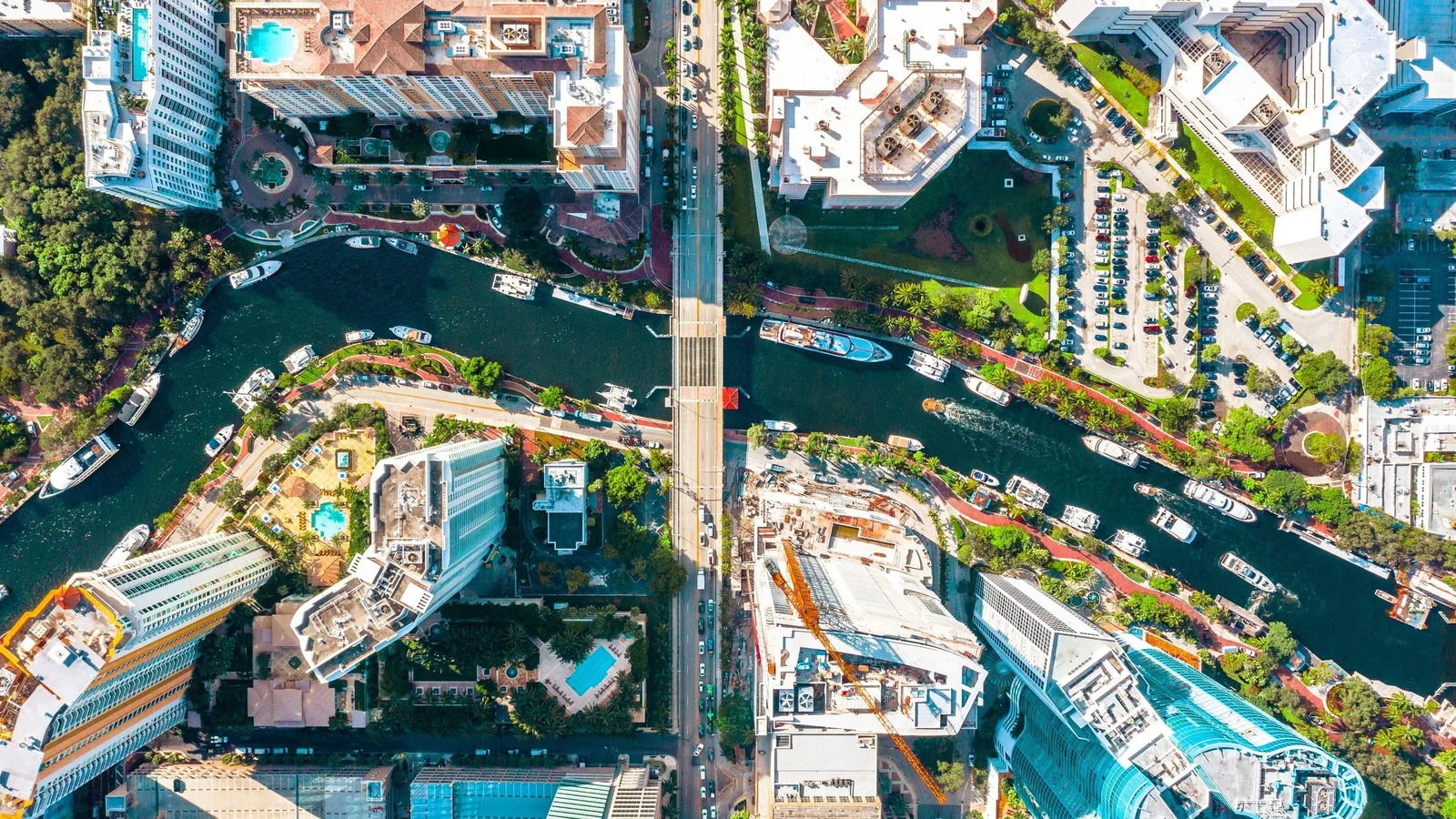 Top-down aerial view of Las Olas condo towers and boat docks on a Fort Lauderdale canal