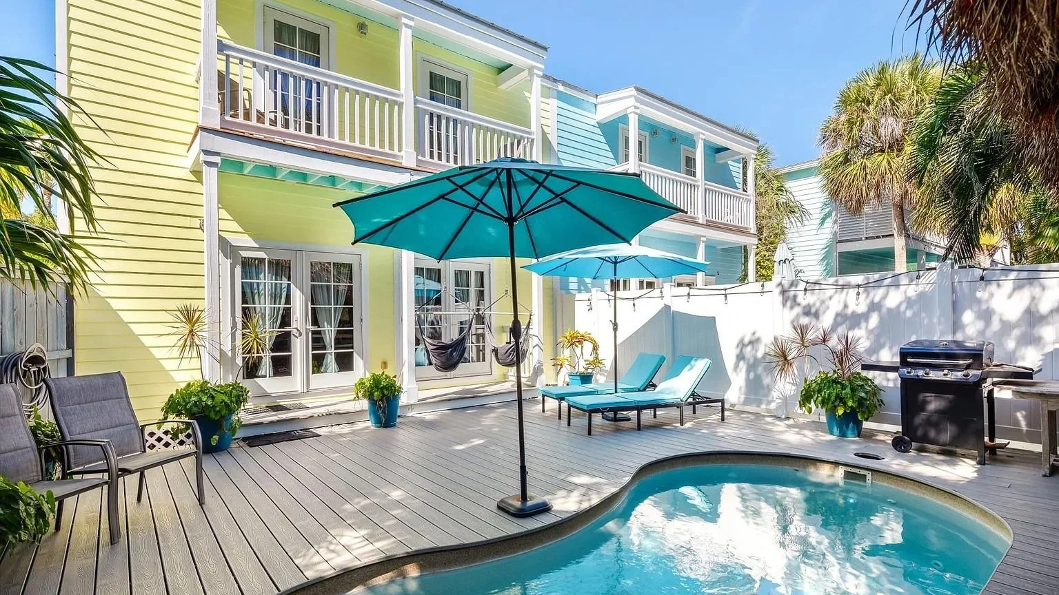 Vacation rental suites with a pool and patio umbrellas in the Florida Keys