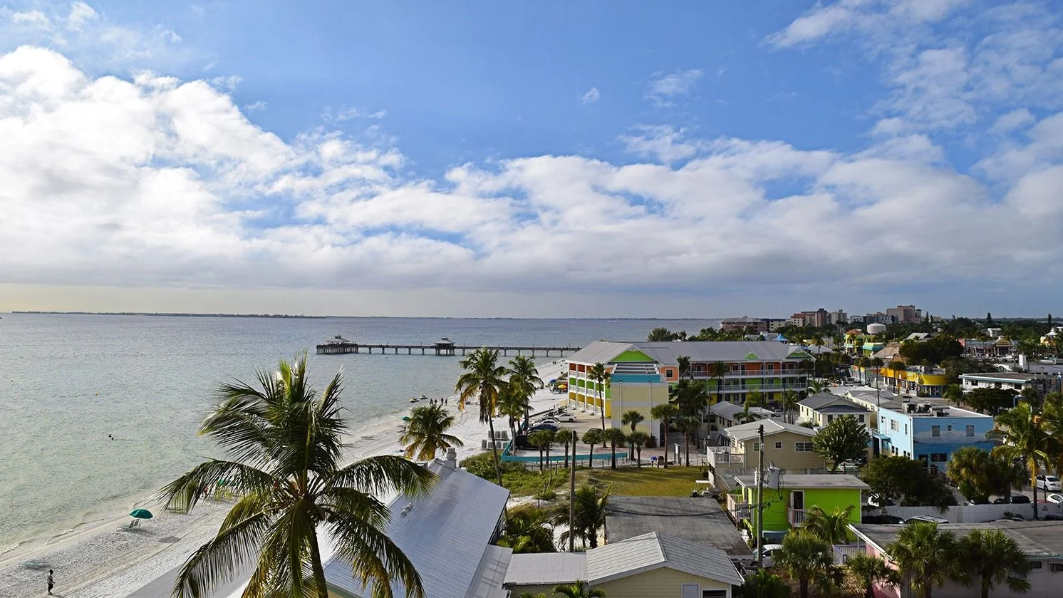 Elevated view of Fort Myers Beach homes, hotels and the fishing pier on the Gulf.