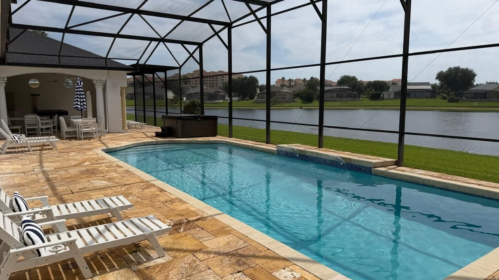 Screened private pool of a Formosa Gardens Estates vacation home overlooking a lake in Kissimmee.