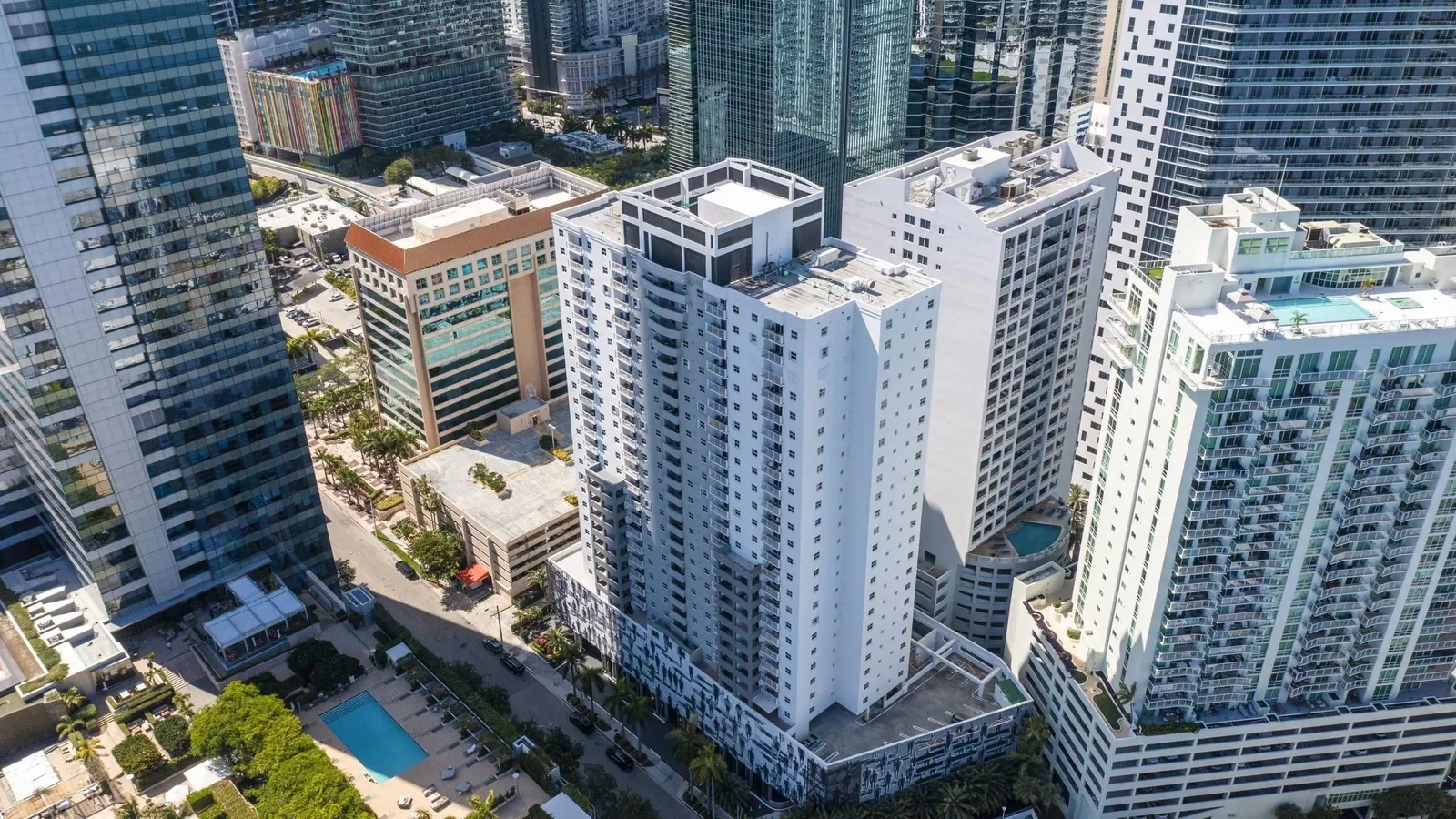 Aerial view of the white Fortune House tower among Brickell high-rises near the bay.
