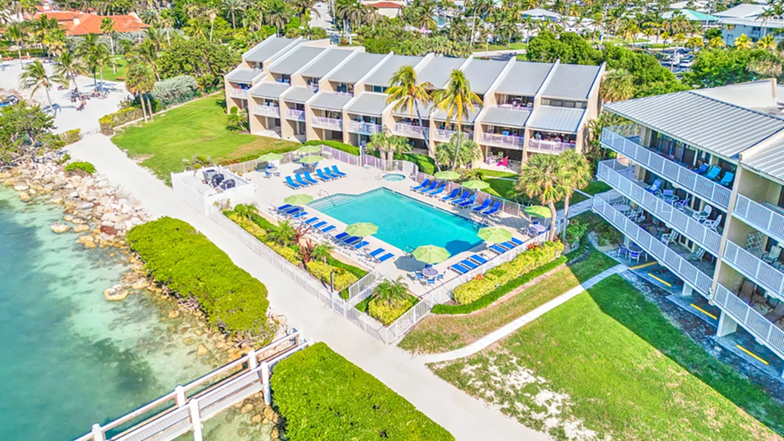 Aerial view of a waterfront condo complex with a pool at Key Colony Point in the Florida Keys