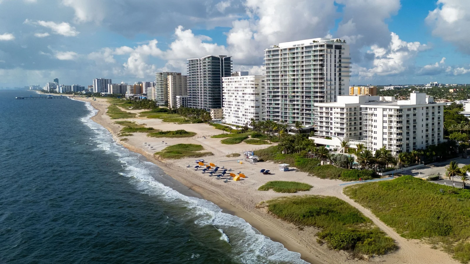 Aerial view of Pompano Beach with condo towers along the dunes and ocean
