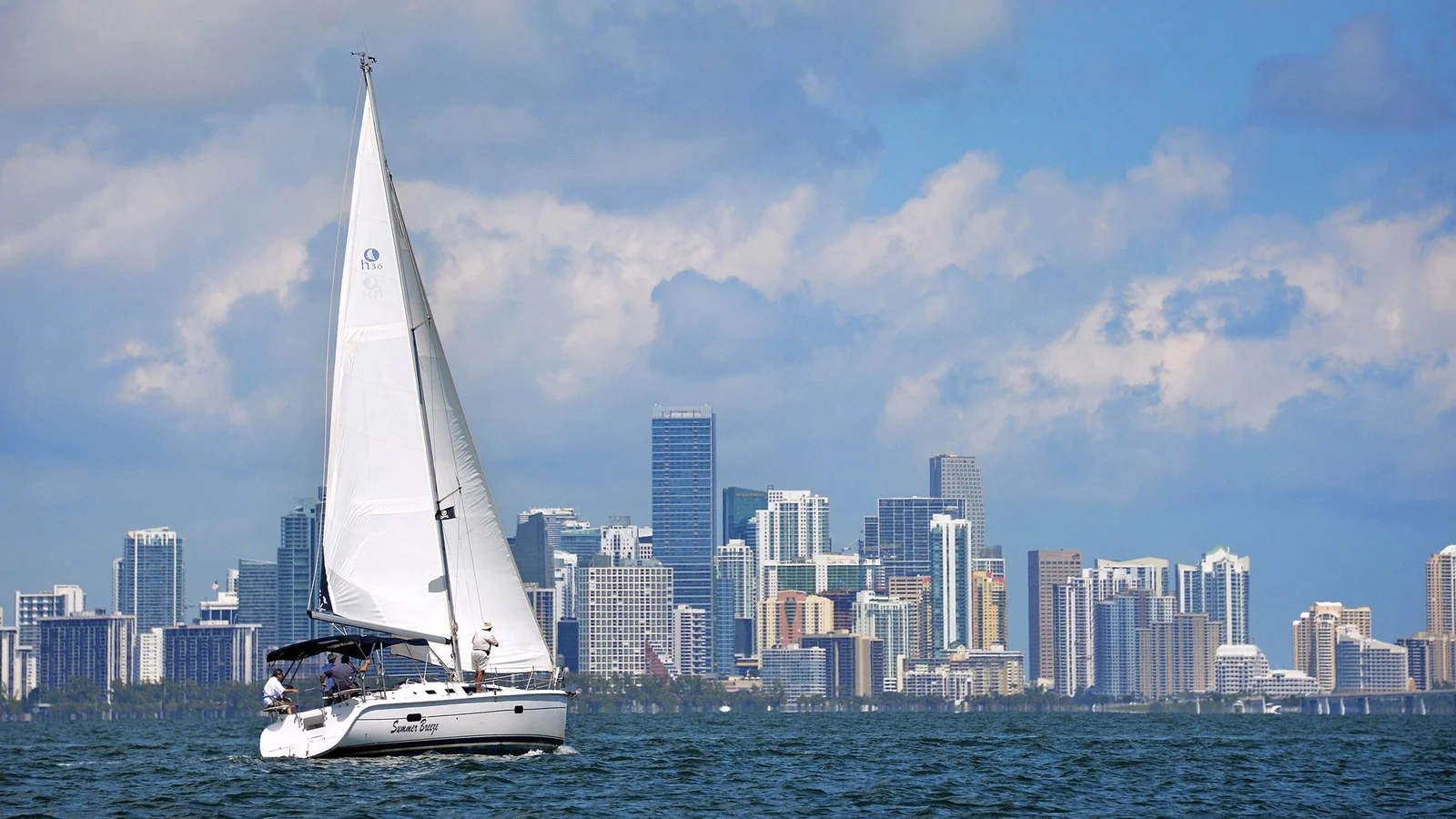 A sailboat on Biscayne Bay in front of the Miami skyline