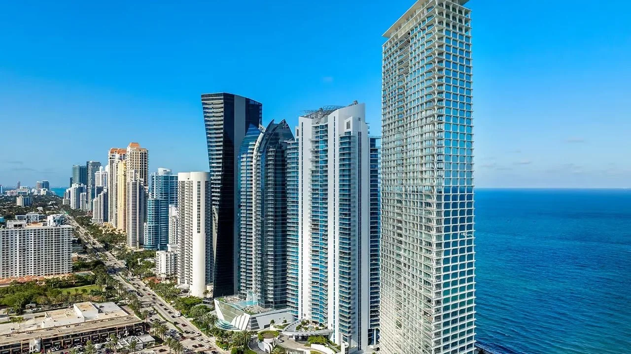 Jade Signature, the tall white tower on the right, beside the Sunny Isles Beach skyline and the Atlantic