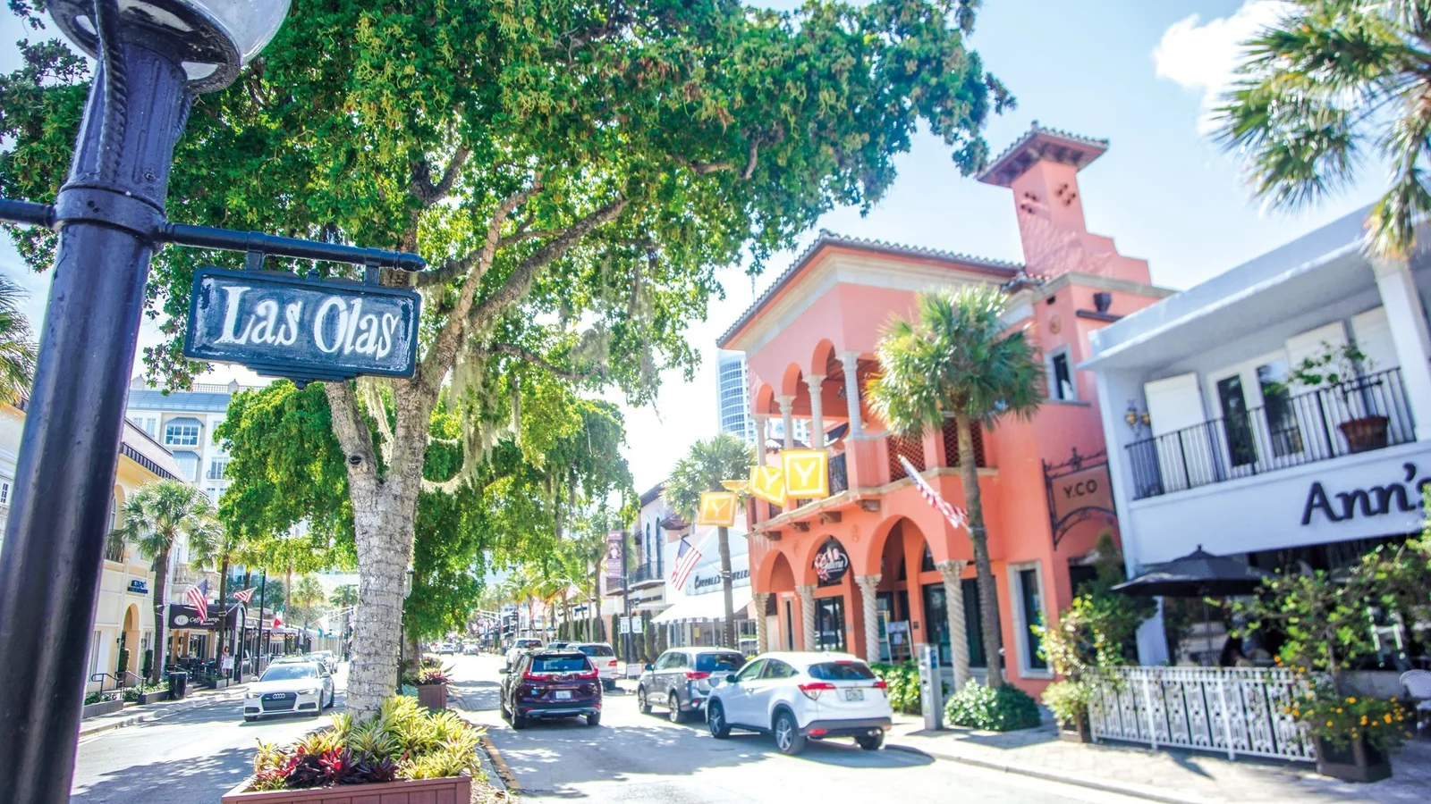 Las Olas Boulevard in downtown Fort Lauderdale with shops and street trees; the photo shows the neighbourhood, not Las Olas River House itself