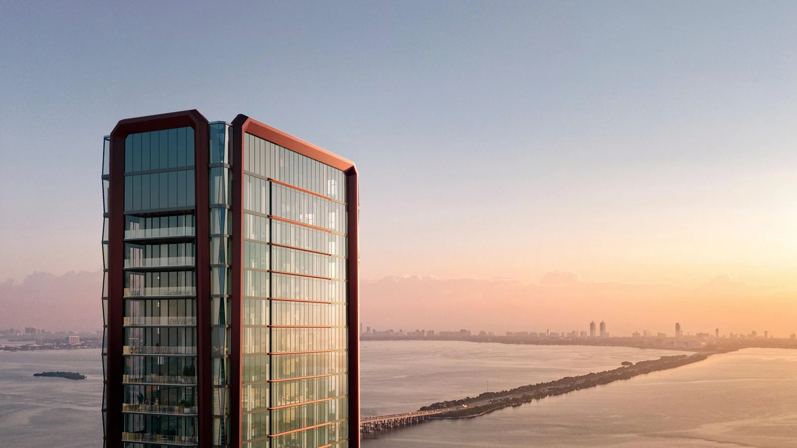 Rendering of the Villa Miami tower by One Thousand Group, with glass facades framed in red, above Biscayne Bay at sunset.