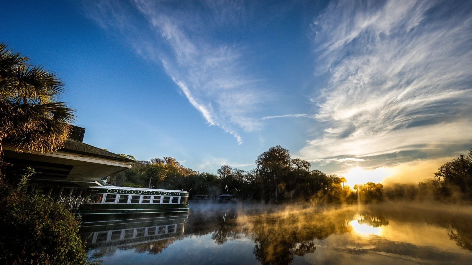 Glass-bottom boat at Silver Springs at dusk with mist on the water