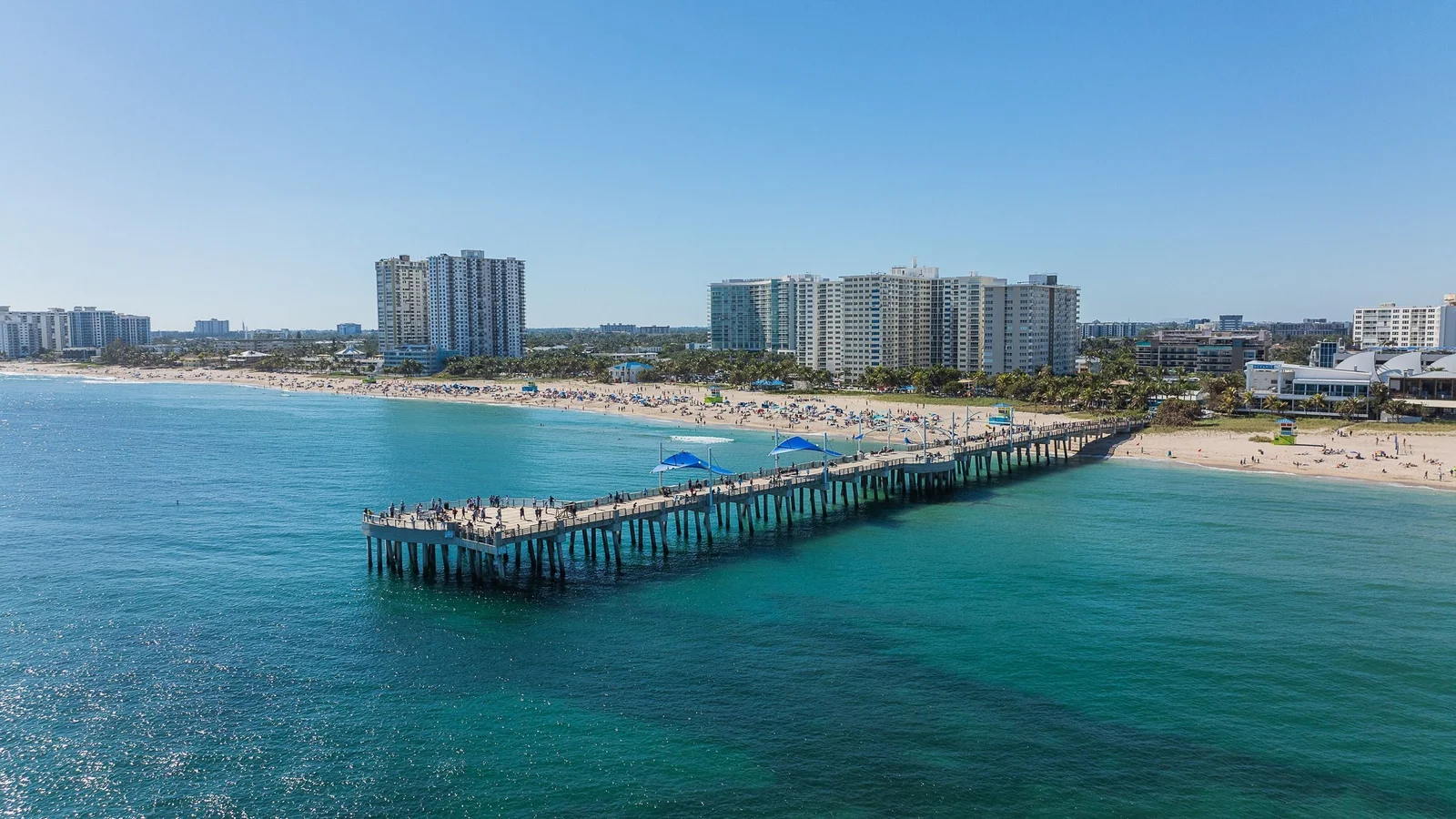 Pompano Beach pier with beachfront condo buildings behind