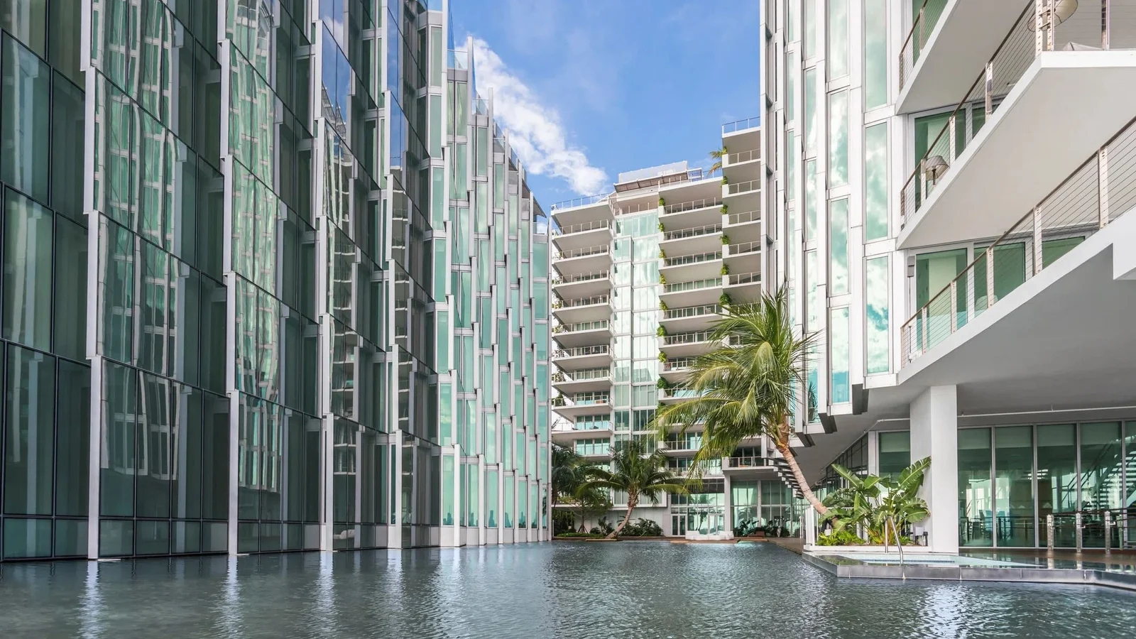Glass facades of Monad Terrace around the reflecting lagoon in its courtyard in Miami Beach