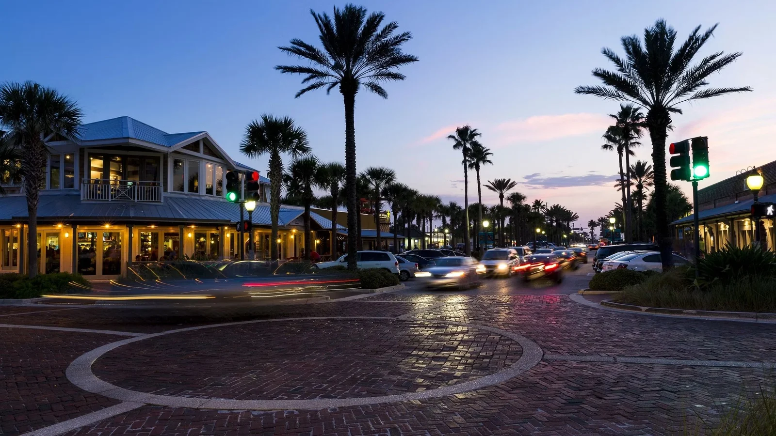 Beaches Town Center with palms and shops at dusk in Neptune Beach, Jacksonville.
