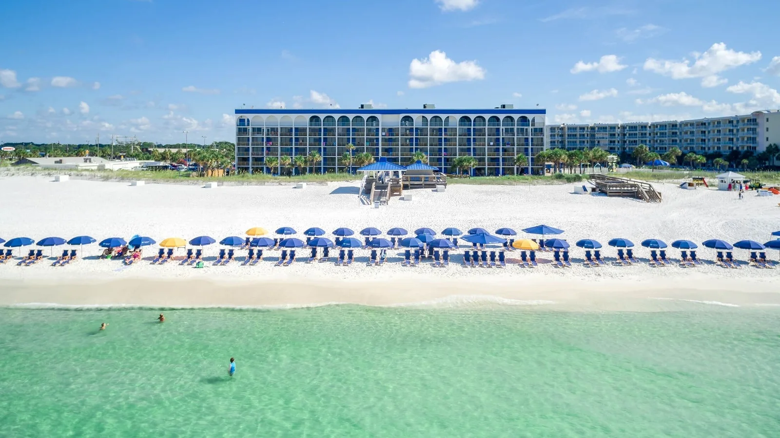 The Island resort on Okaloosa Island in Fort Walton Beach with beach umbrellas and clear Gulf water