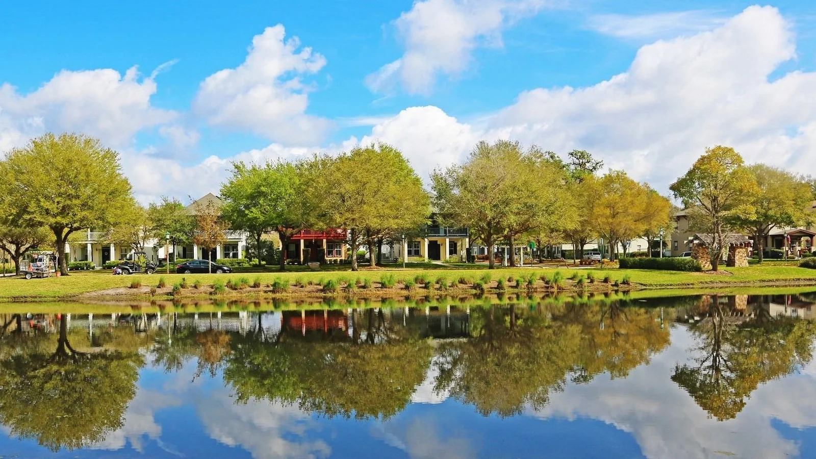 Trees and buildings reflected in a lake in Celebration, Osceola County.