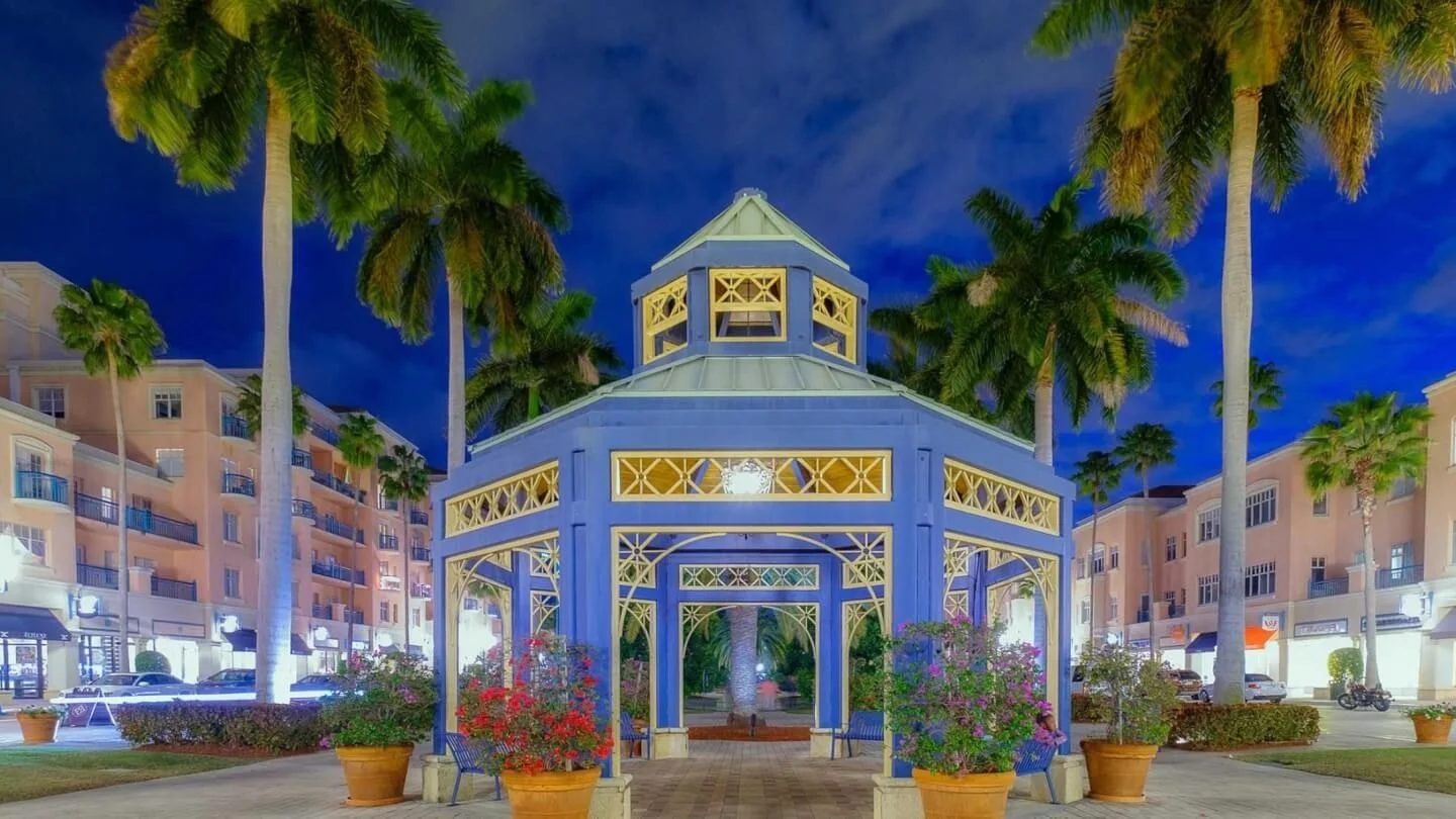 Mizner Park in downtown Boca Raton at twilight with its lit pavilion and palm trees