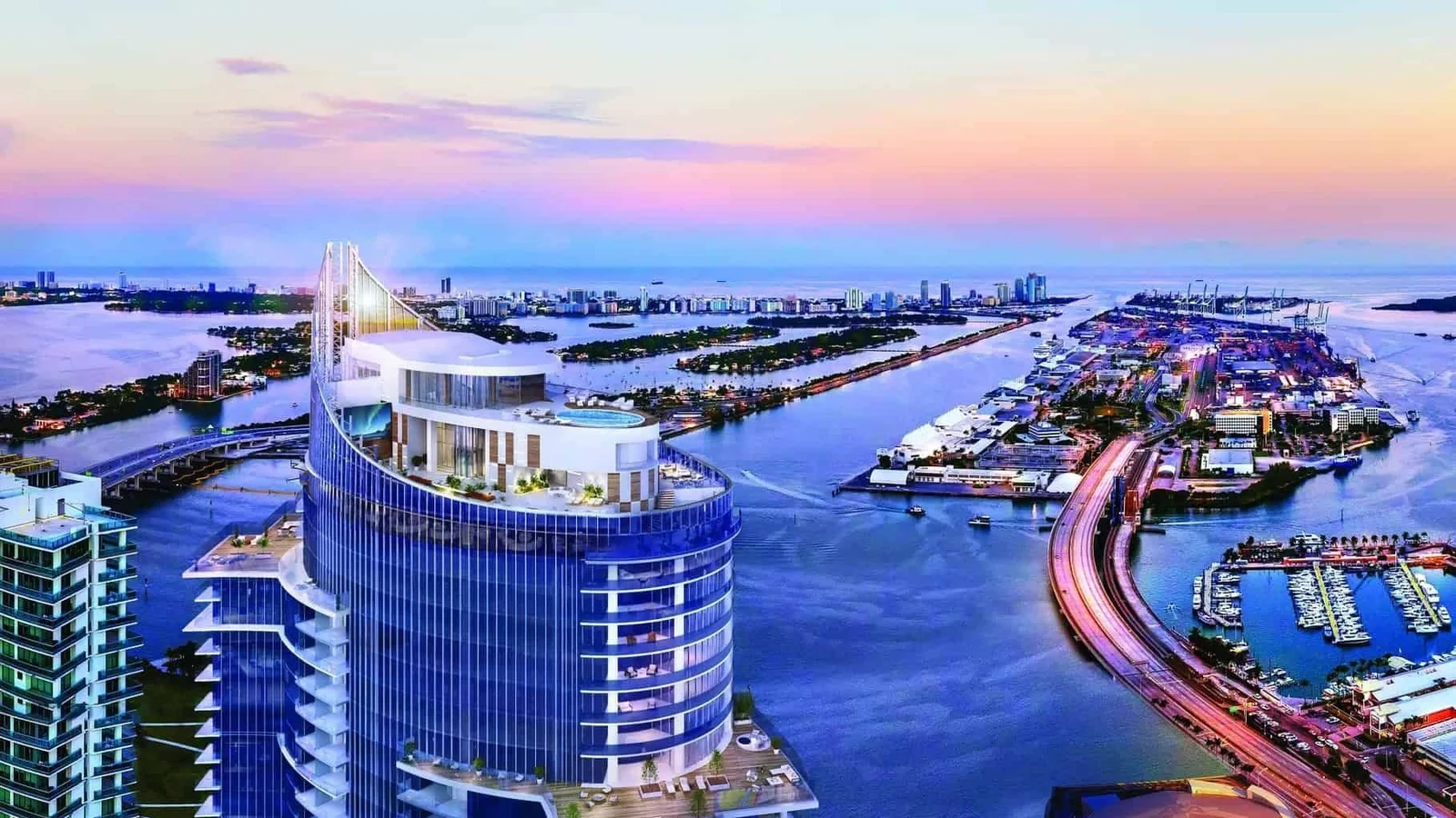 Rendering of the top of Paramount Miami Worldcenter with its rooftop pool deck, overlooking Biscayne Bay, the causeways and PortMiami at dusk.