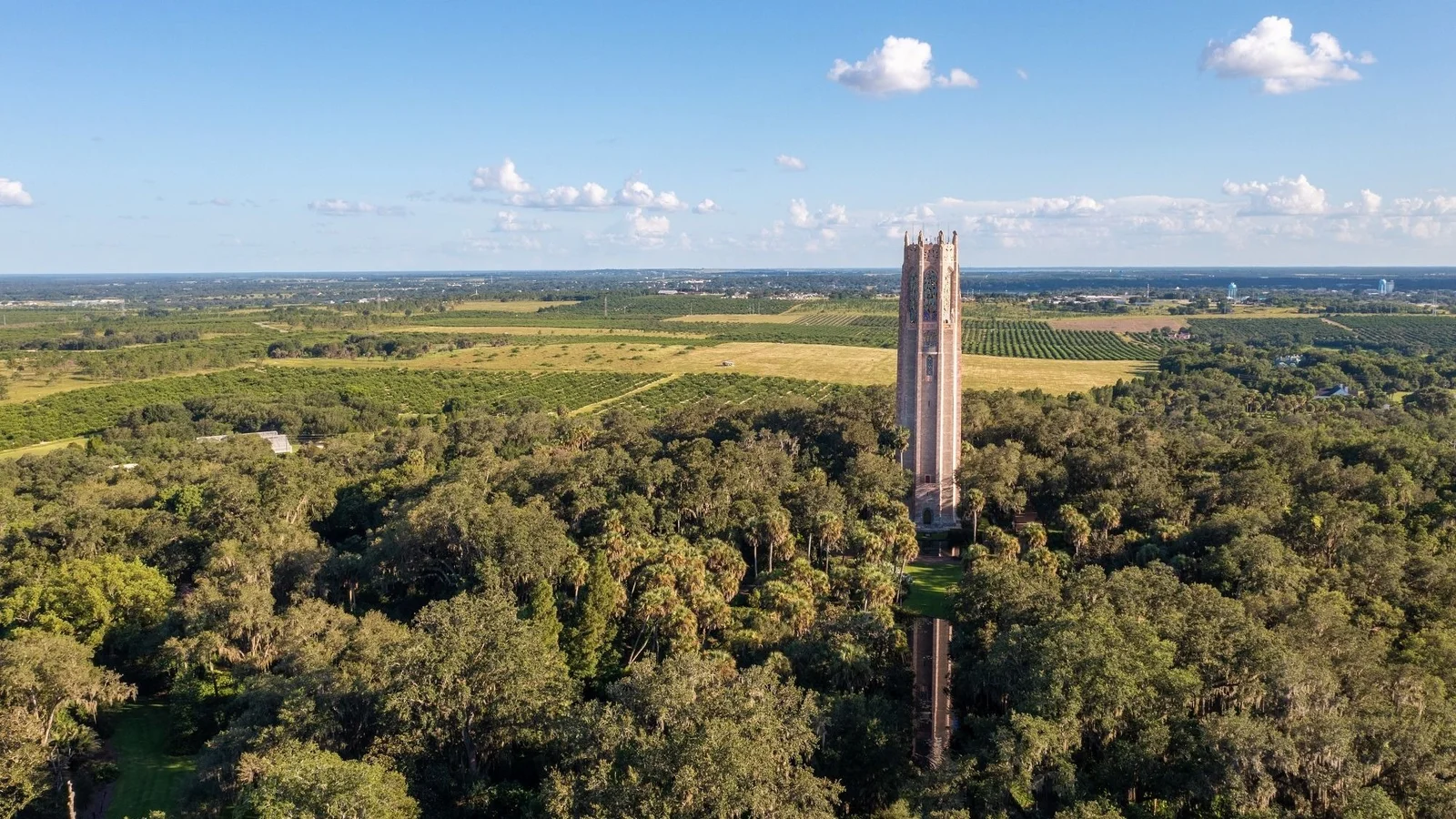 Aerial view of Bok Tower rising above the forest and citrus groves near Lake Wales in Polk County.
