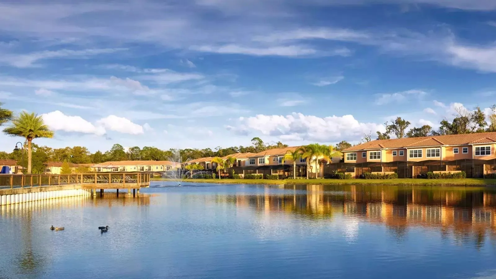 Regal Oaks Resort townhomes reflected in the resort lake in Kissimmee.