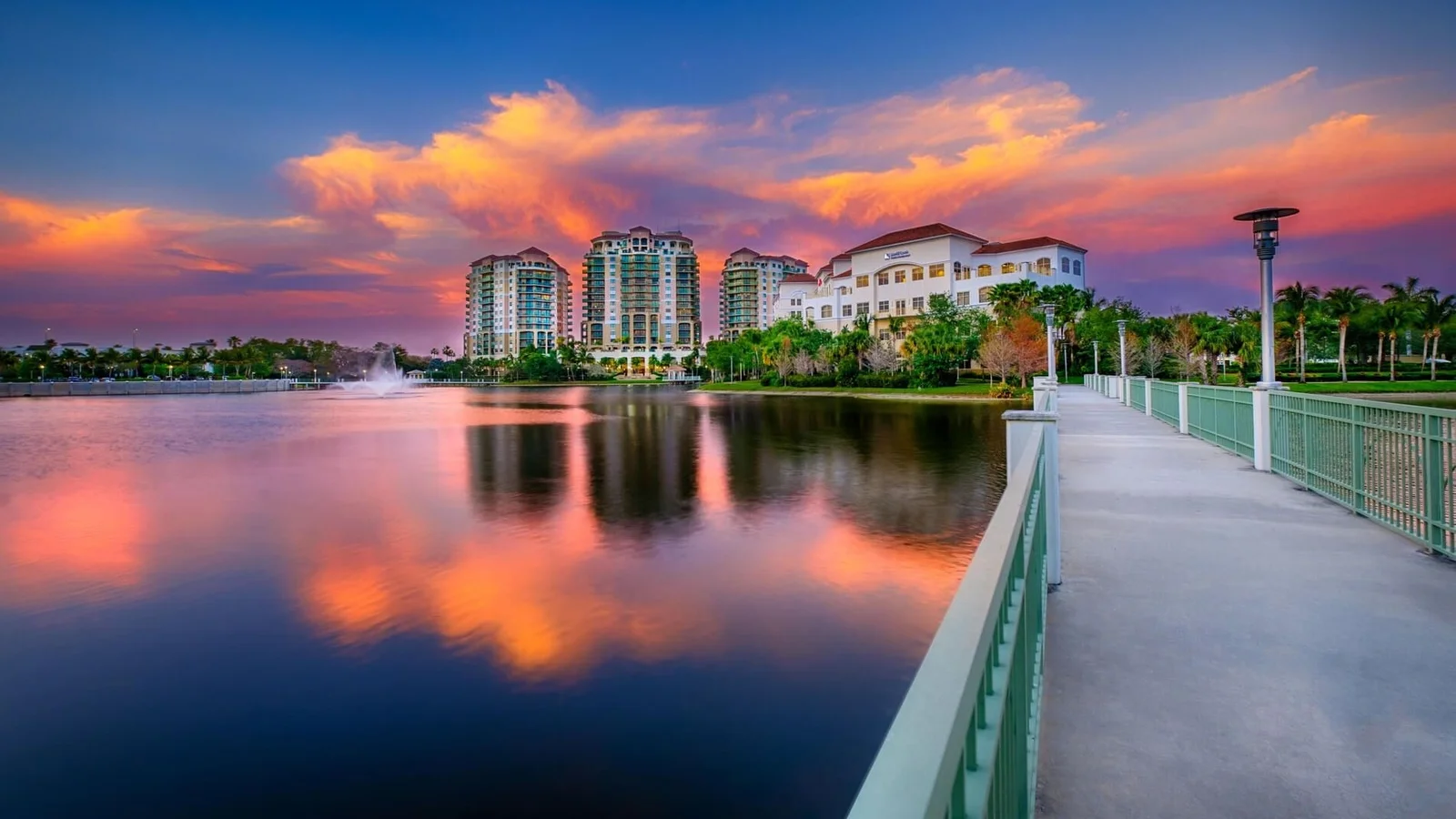 Condo buildings across a lake at sunset in downtown Palm Beach Gardens