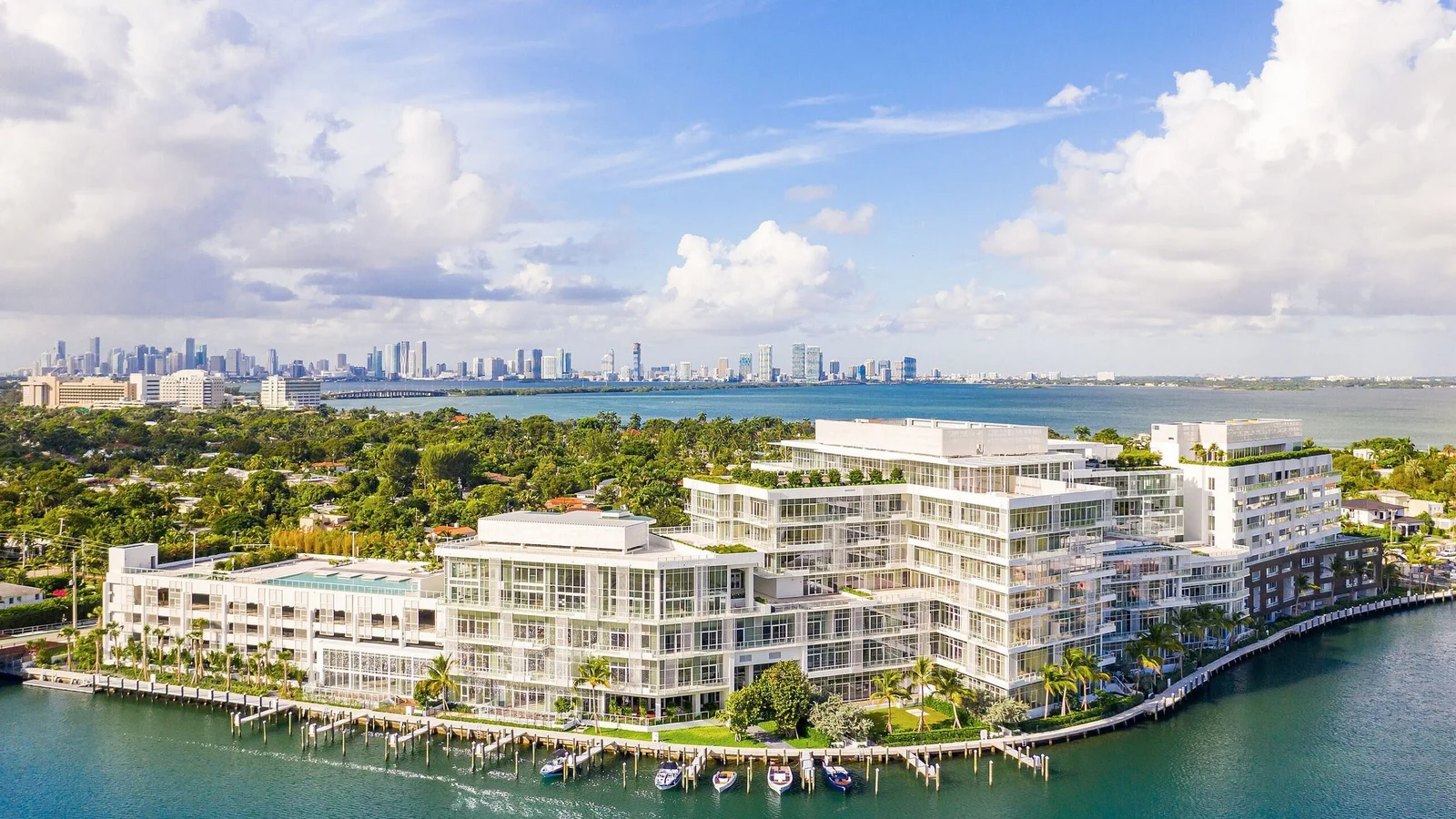 Aerial view of the Ritz-Carlton Residences on Surprise Lake in Miami Beach, with the Miami skyline across the bay