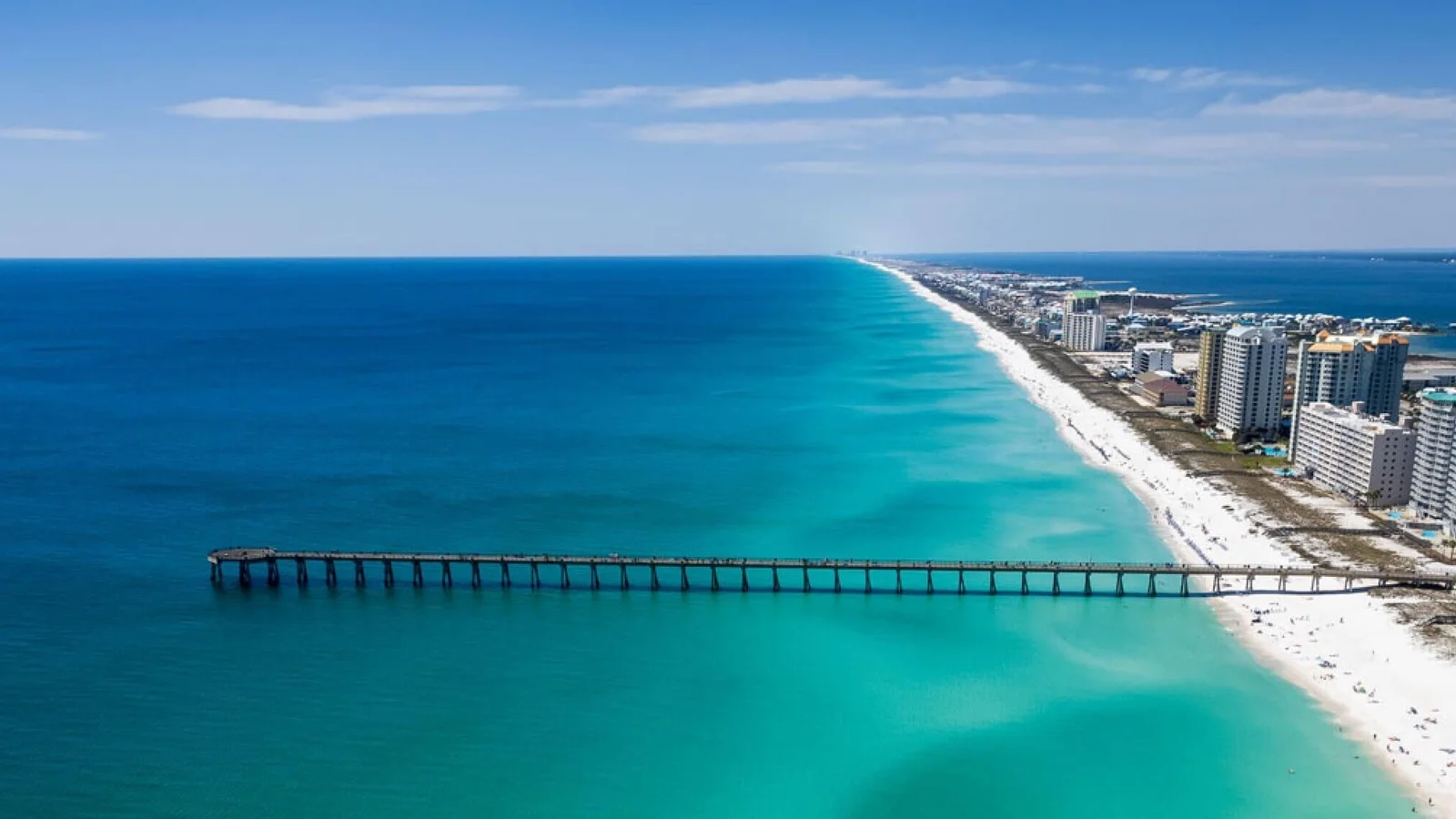 Aerial view of Navarre Beach with the Navarre Beach Pier and beachfront condos