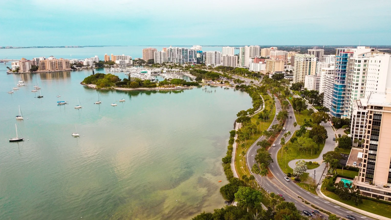 Aerial view of downtown Sarasota's bayfront high-rises, Bayfront Park and boats on Sarasota Bay.