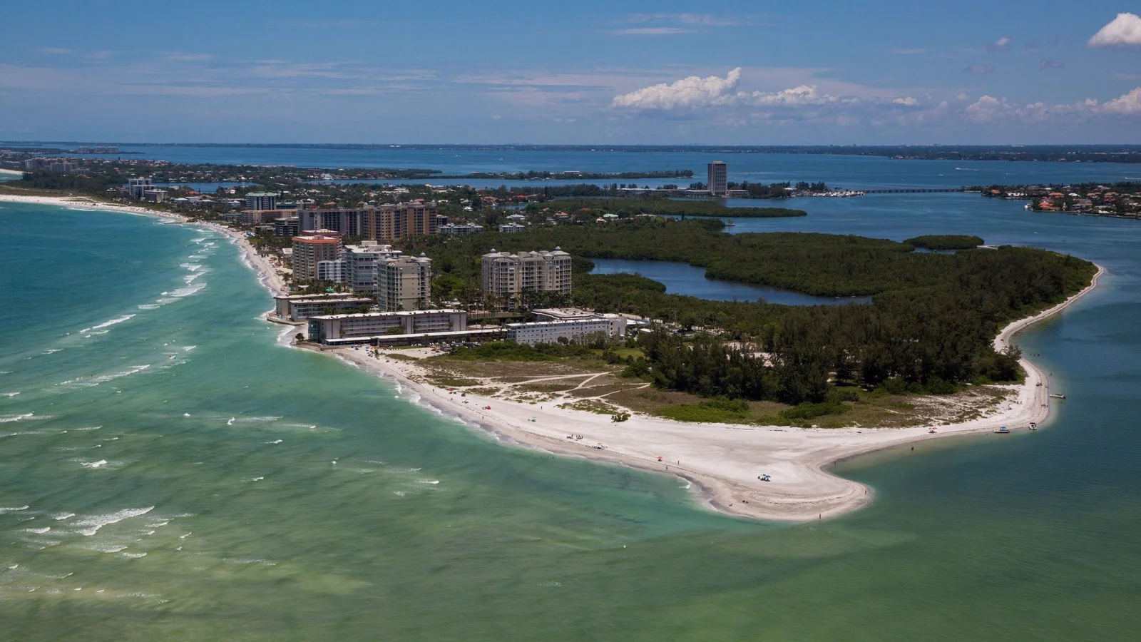 Aerial view of Lido Key in Sarasota with beachfront condos and turquoise Gulf water