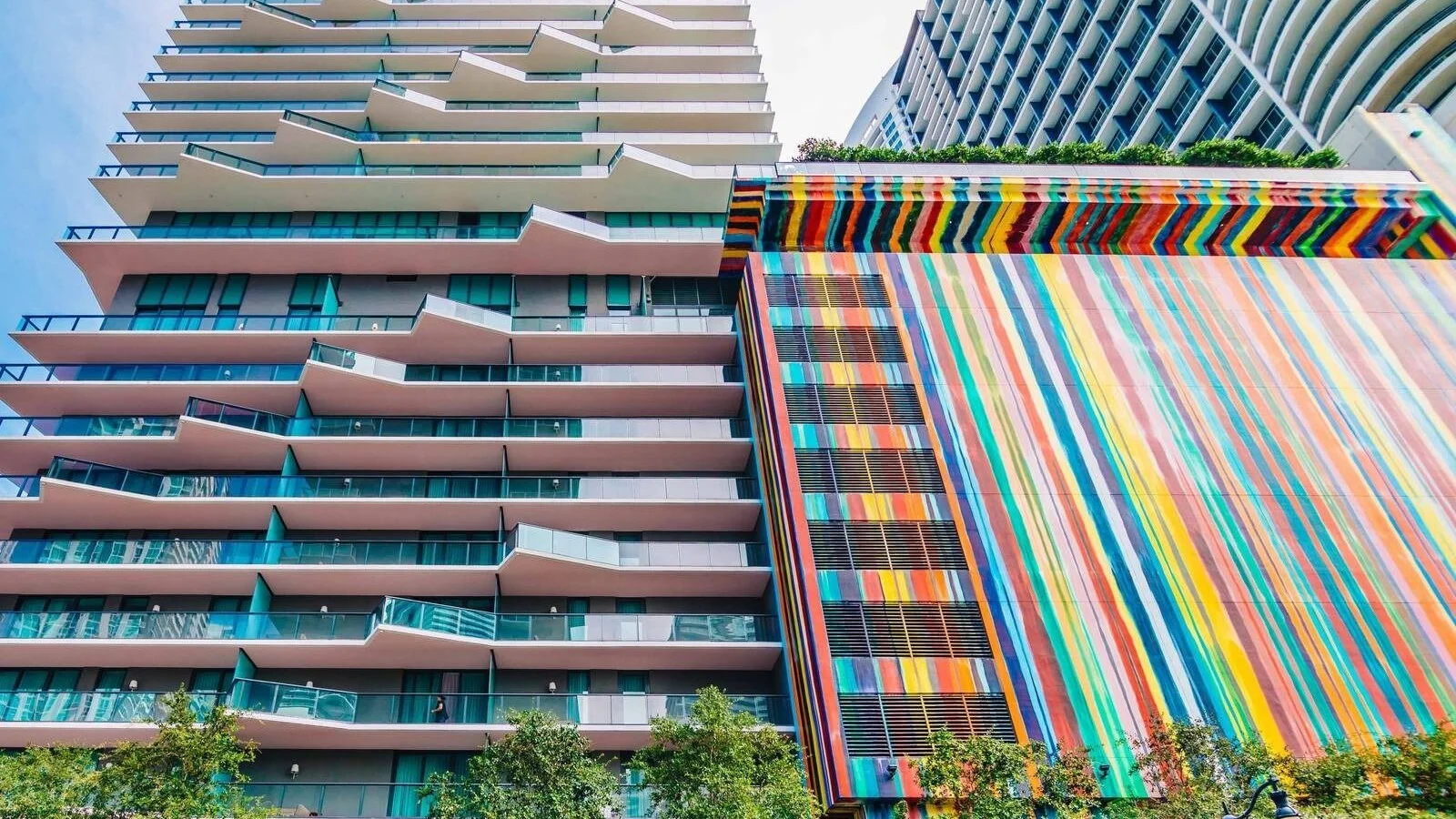 The Dua Miami tower, formerly SLS Brickell, with its stepped balconies and colourful striped garage facade.