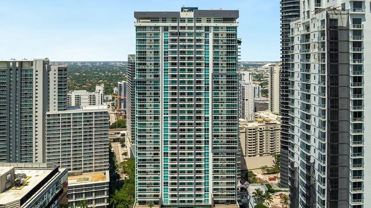 The Bond on Brickell condo tower seen from above among neighbouring Brickell buildings.