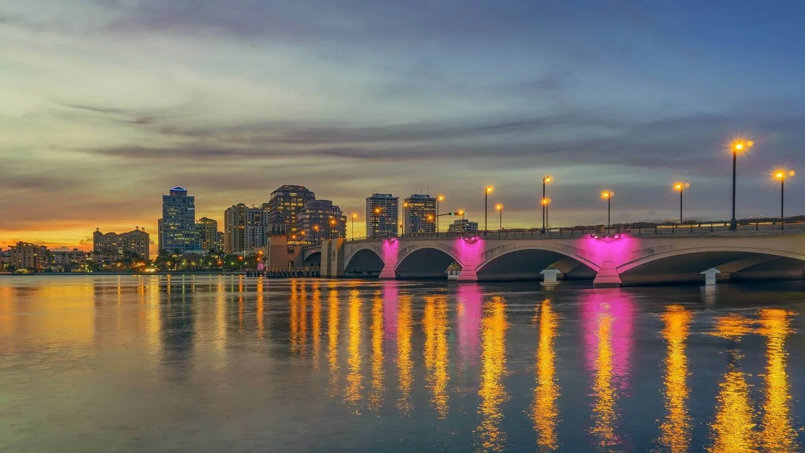 West Palm Beach skyline at dusk behind the lit Royal Park Bridge