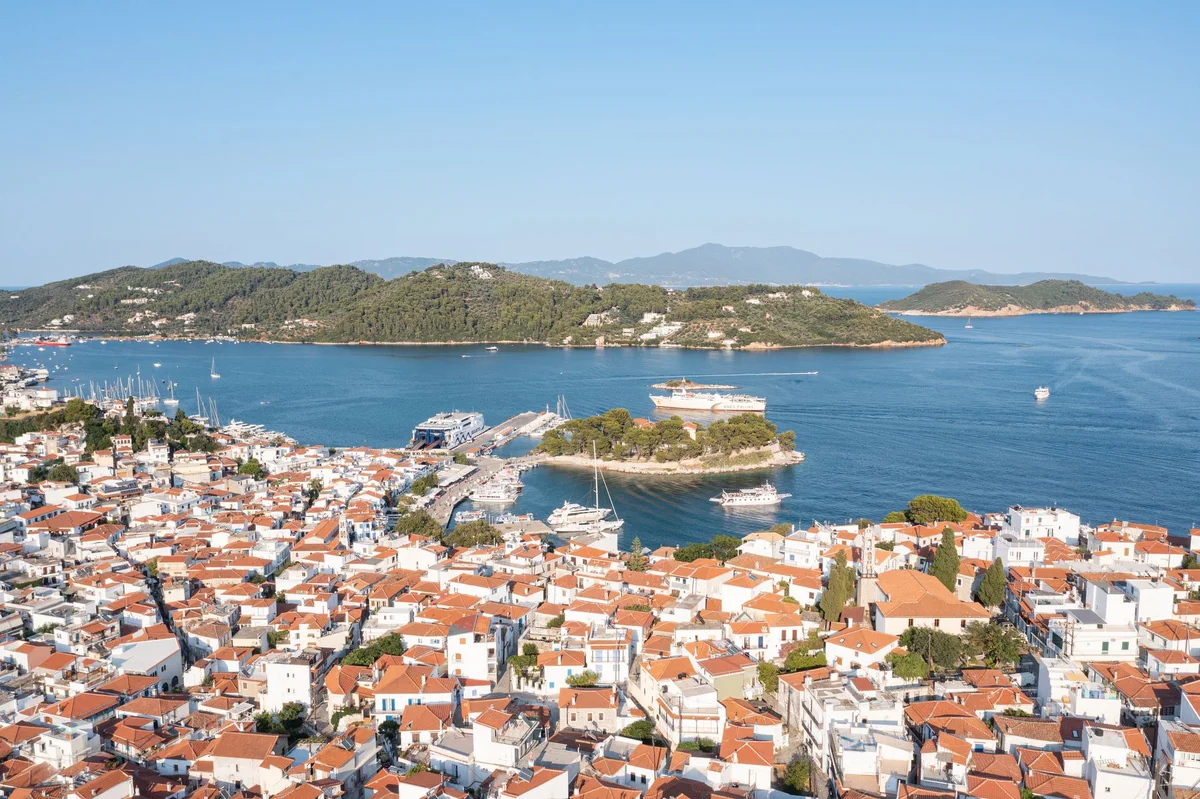 Skiathos town seen from above, its tiled roofs running down to the harbour and the Bourtzi peninsula