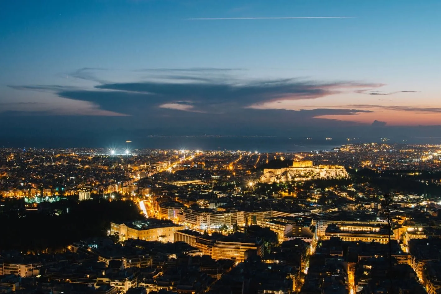 Athens lit up at dusk with the Acropolis in the centre