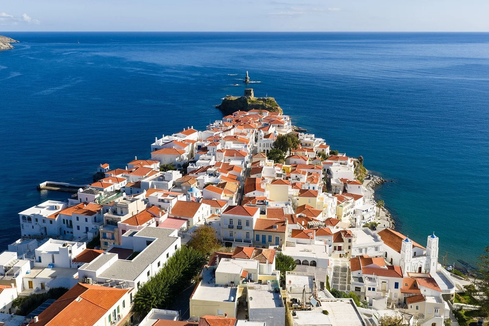 Aerial view of a Cycladic island town on a narrow headland