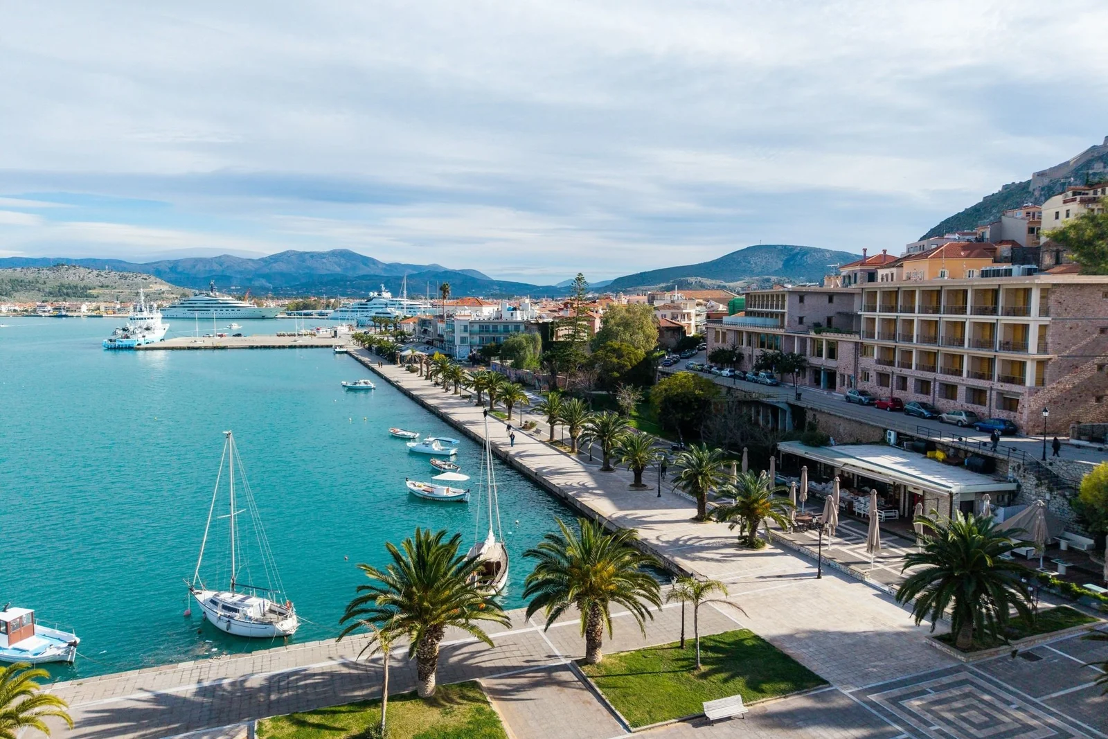 Nafplio waterfront promenade with palms and moored boats