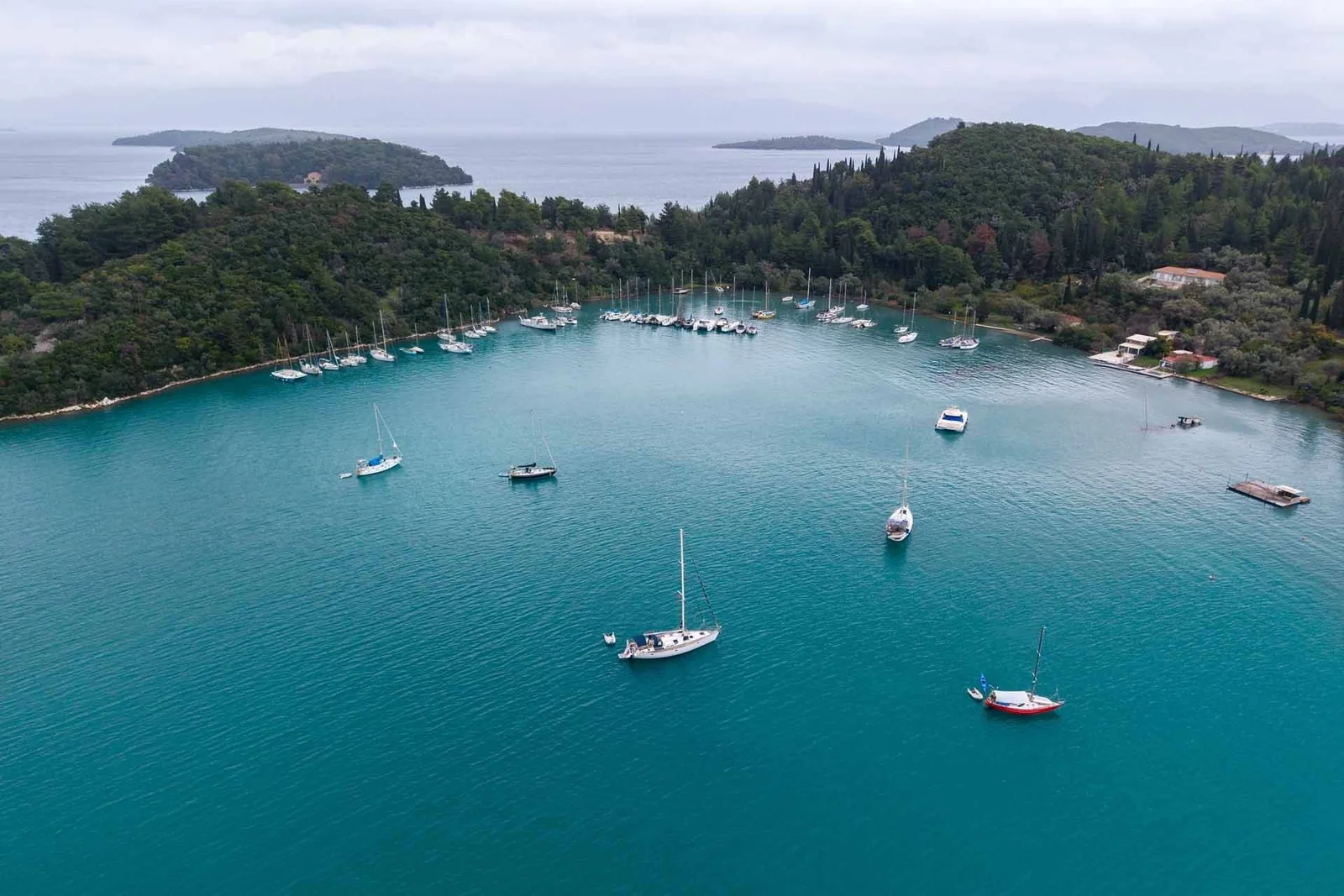 Sailing boats at anchor in a green bay on Lefkada