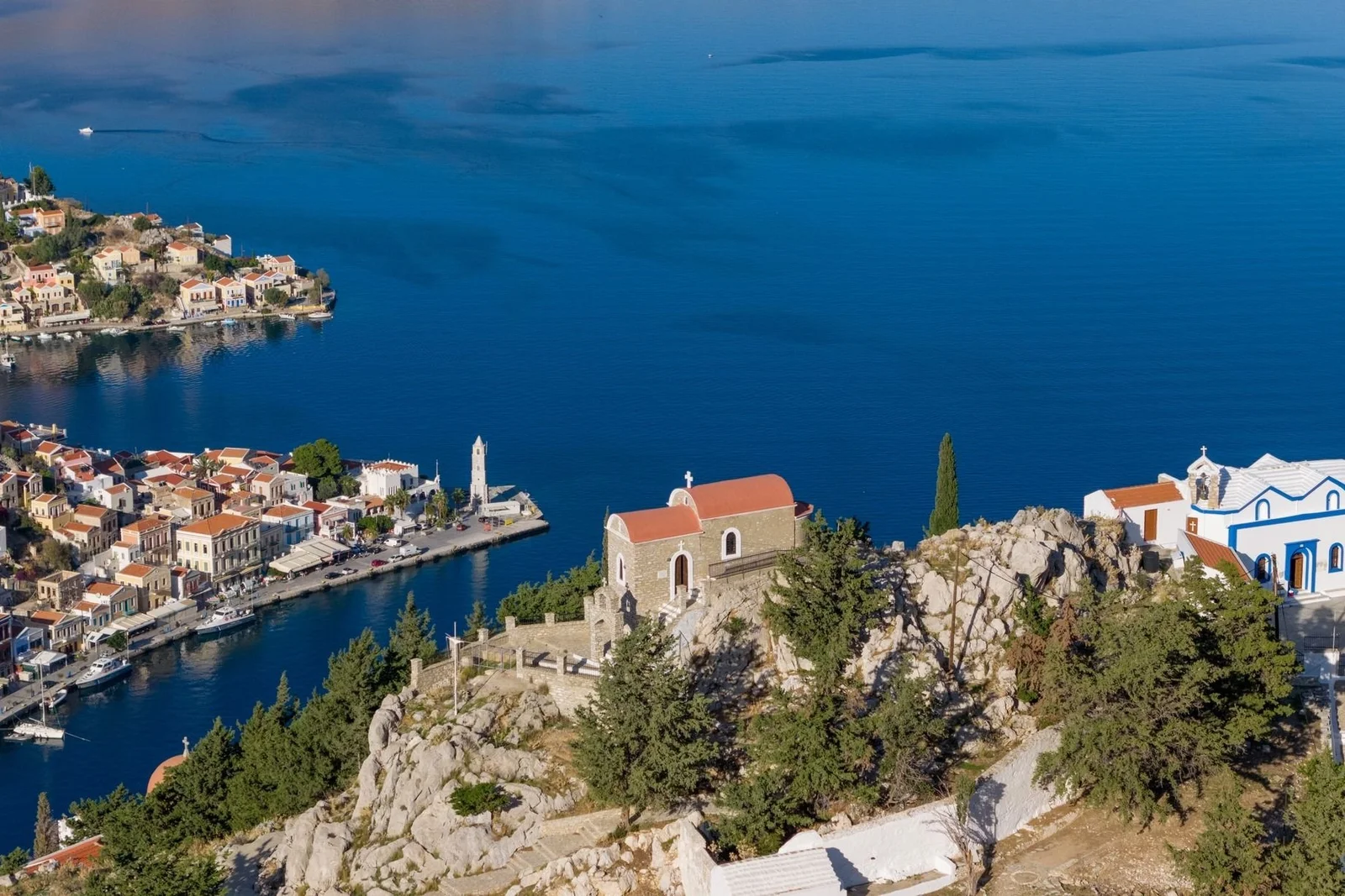 Aerial view of Symi harbour and its hillside chapels