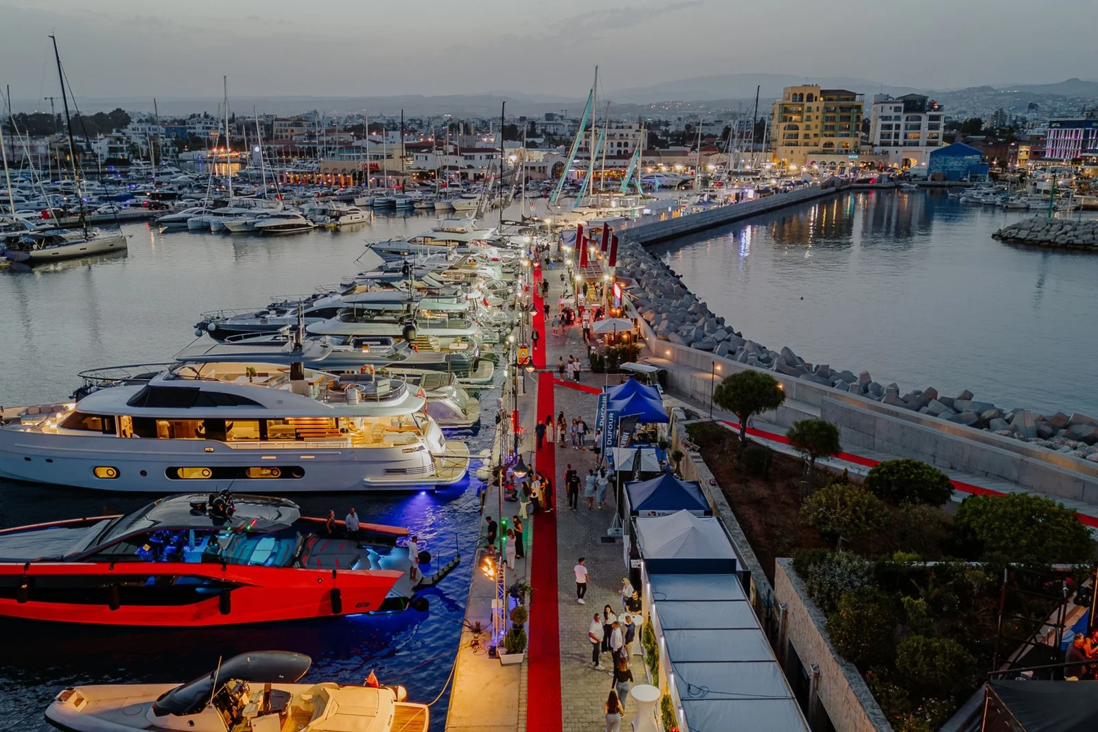 Motor yachts along a lit pontoon at Limassol Marina, Cyprus