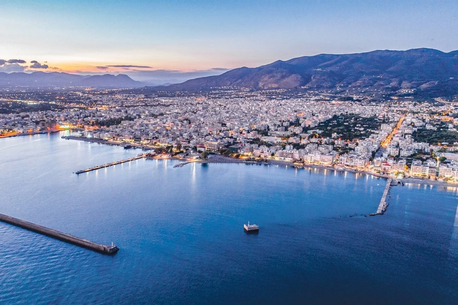 Kalamata waterfront and harbour at dusk below the Taygetos mountains
