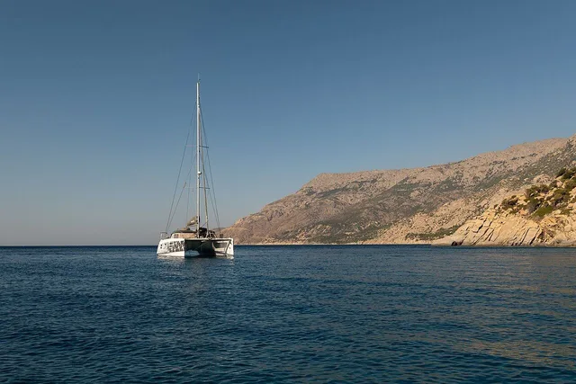 Sailing catamaran anchored off the Seichelles Beach, Ikaria, Greece julesvernex2