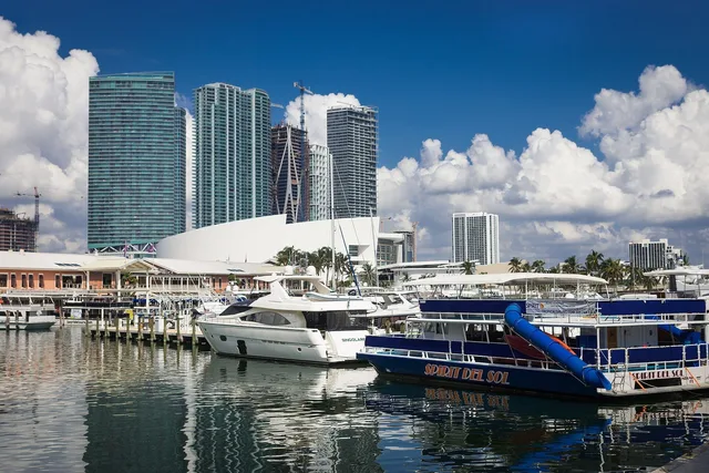 Motor yachts berthed at Bayside Marina with the Miami skyline behind